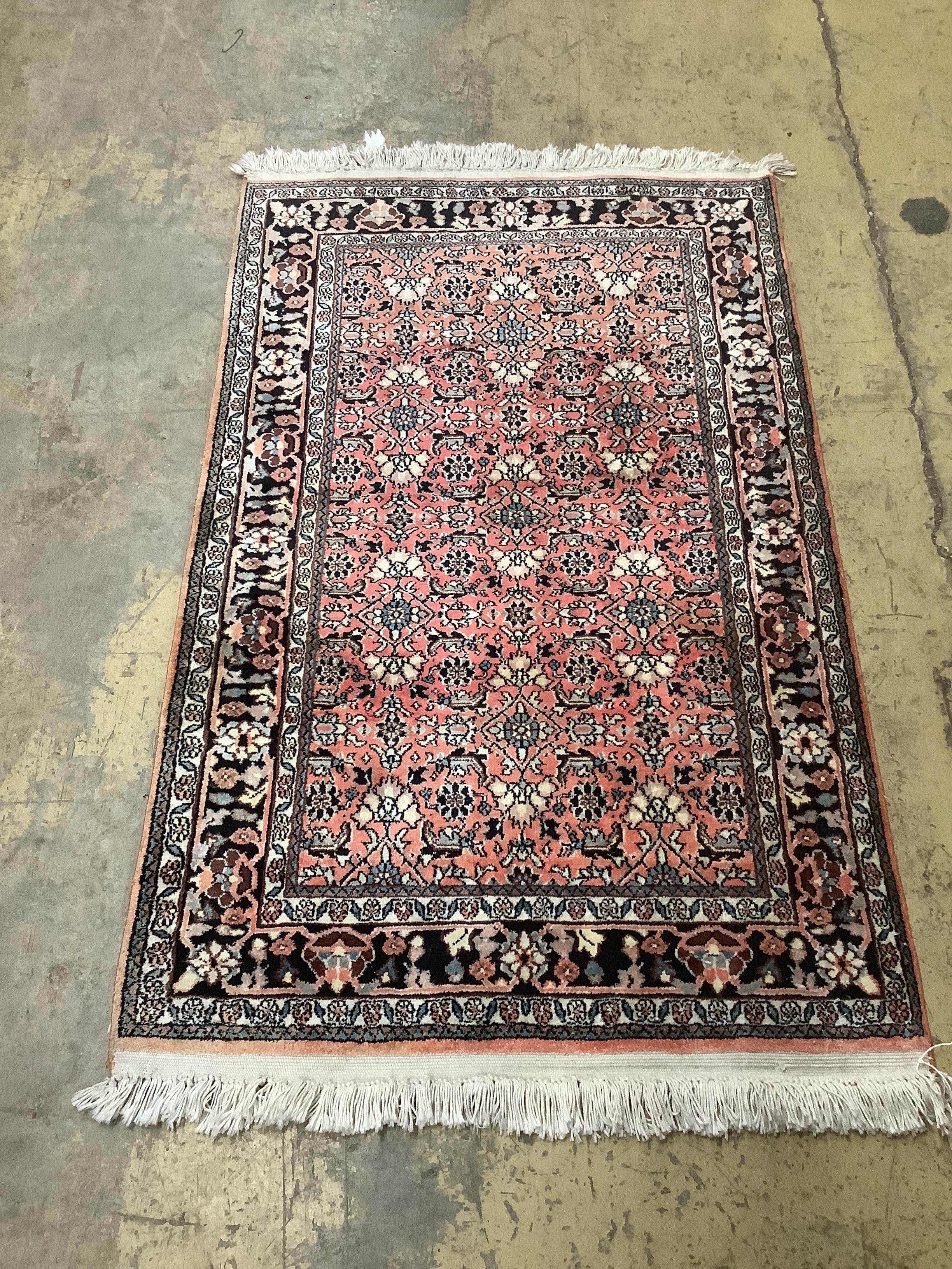 A North West Persian peach ground rug,120 x 76cm